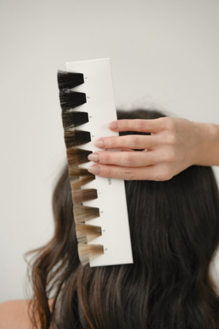 Hand tied extension wefts matched against a client's hair
