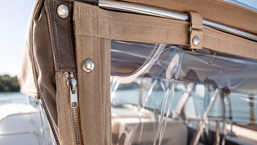 Detail of enclosure glazing with zipper and fasteners